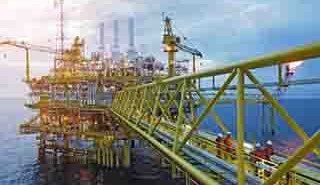 FRP grating walkways and cable management routes integrated into the steel framework of an offshore oil platform deck.