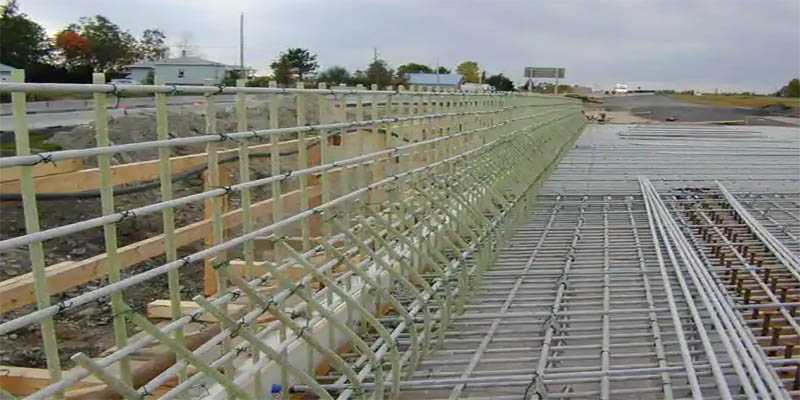 Reinforcement bars arranged across a bridge deck before concrete placement, showing the grid layout and bar positioning.